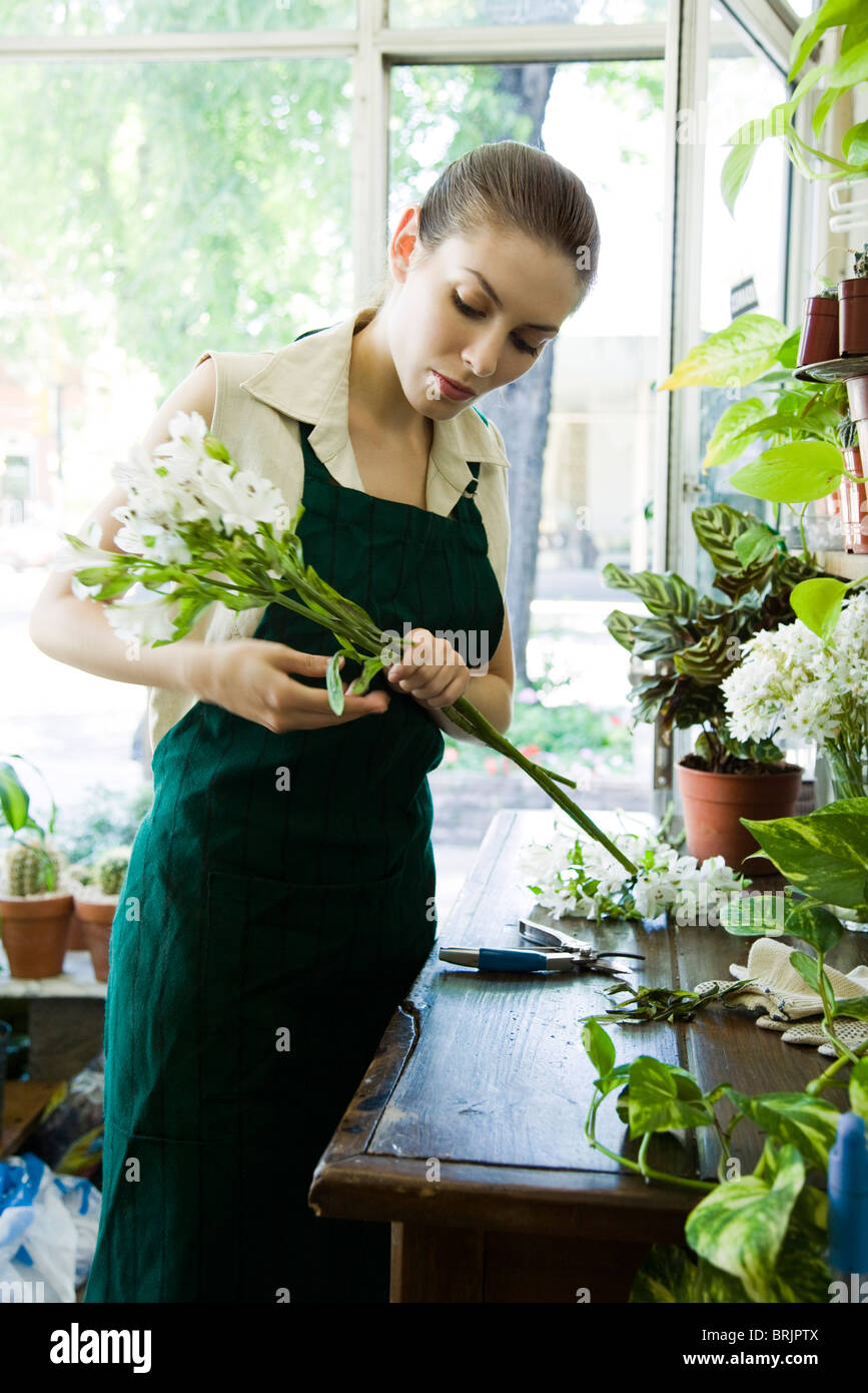 Female florist arranging flowers in shop Stock Photo