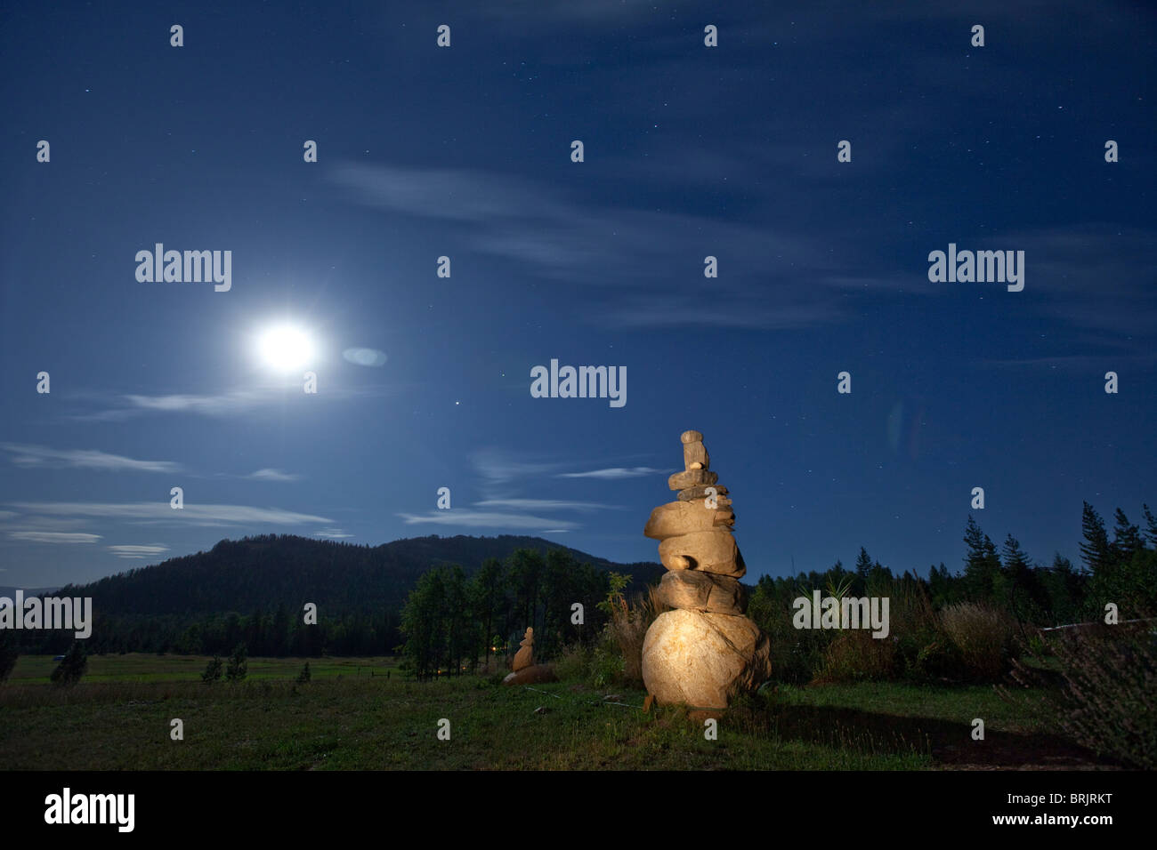Rock cairn with a full moon in background in Idaho. Stock Photo