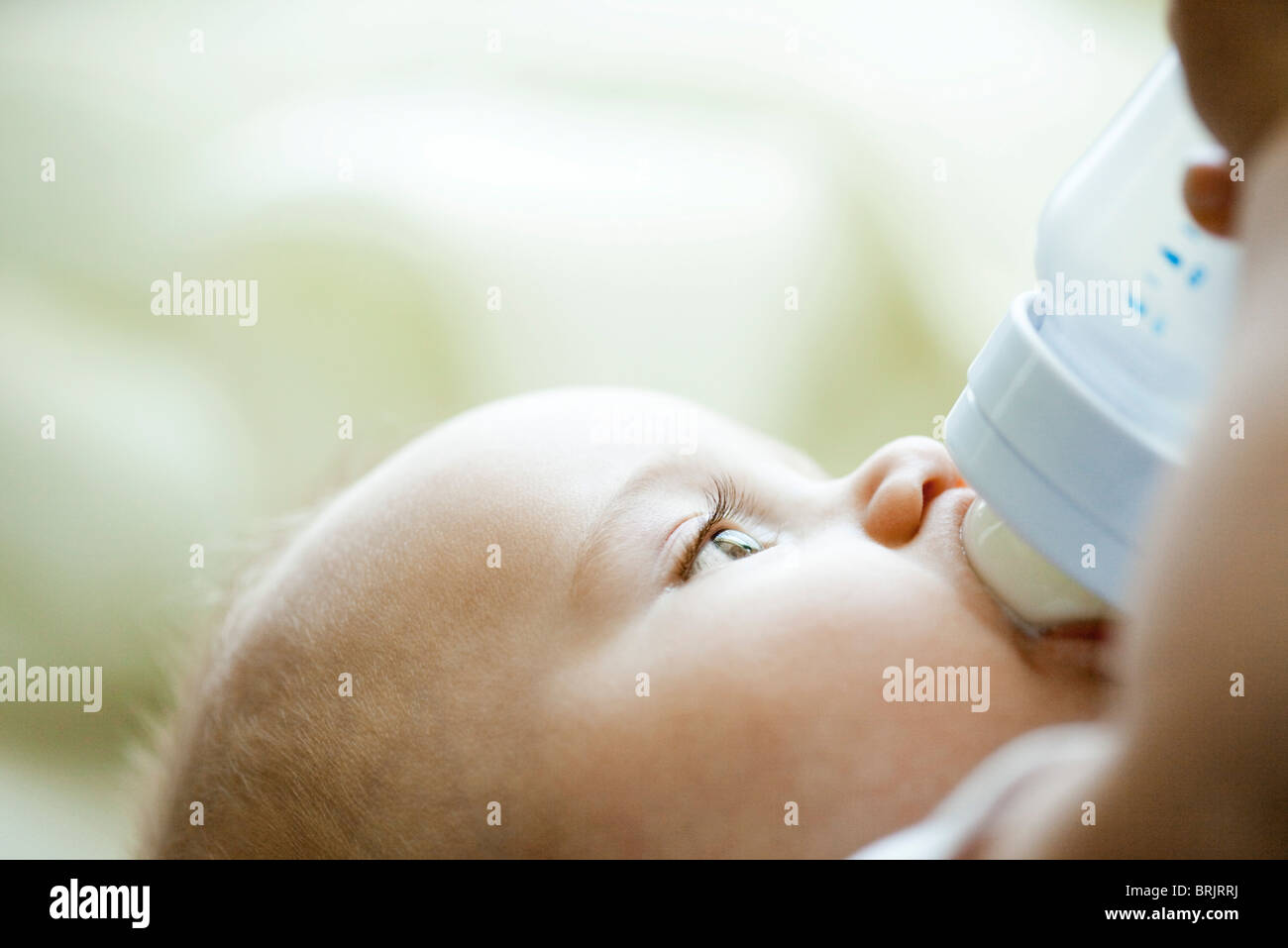 Baby drinking from bottle Stock Photo
