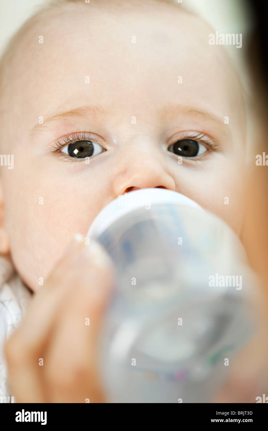 Baby drinking from bottle Stock Photo Alamy