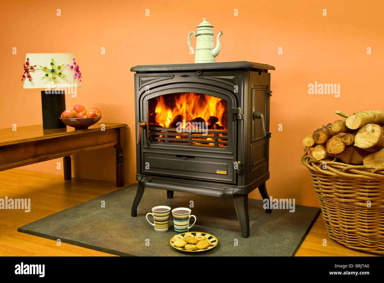 A Franco Belge Limousin wood burning stove with roaring flames Stock
