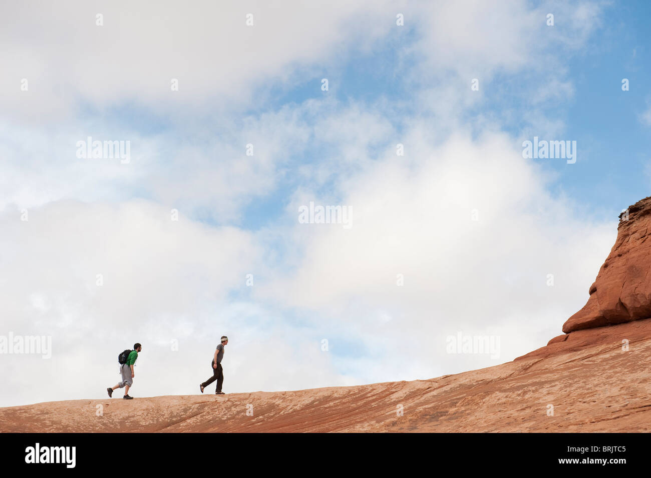 Two young men hiking in Arches National Park, Moab, UT. Stock Photo
