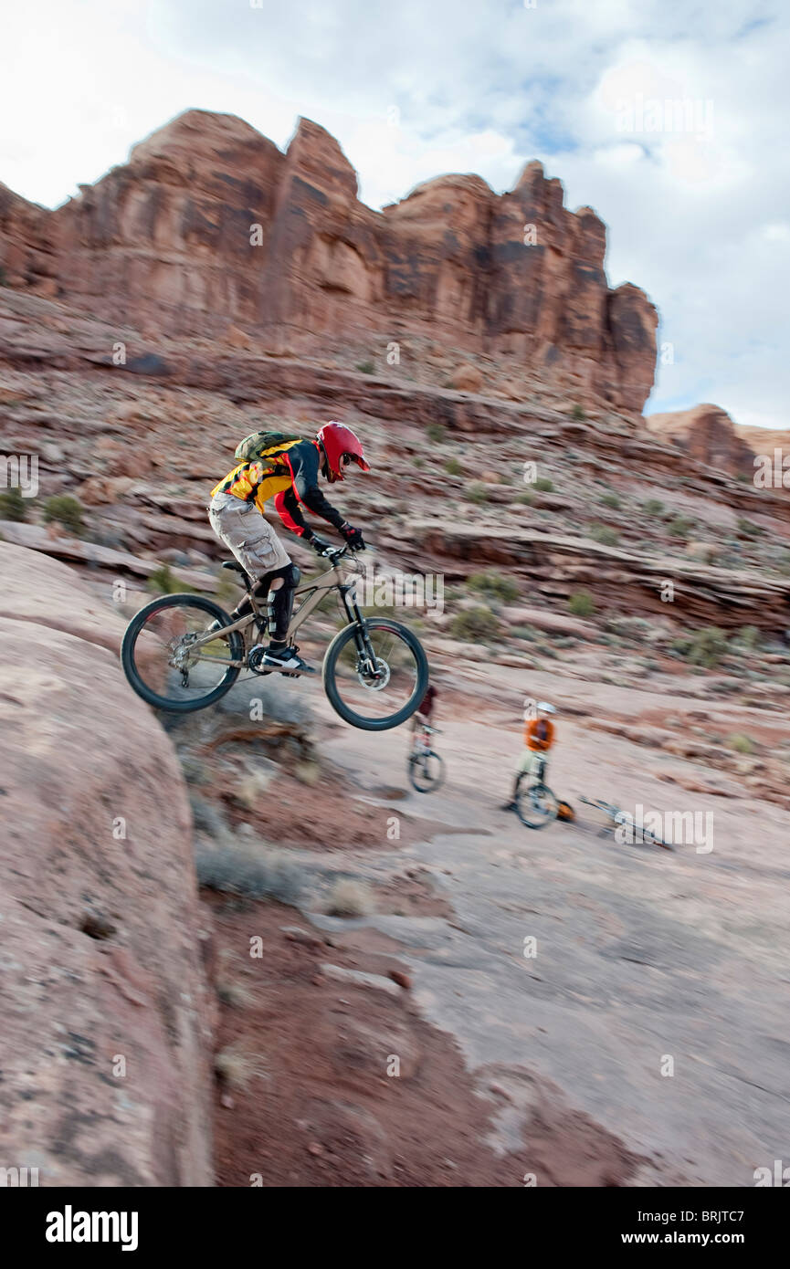 A downhill mountain biker launches off a drop on the Amasa Back Trail