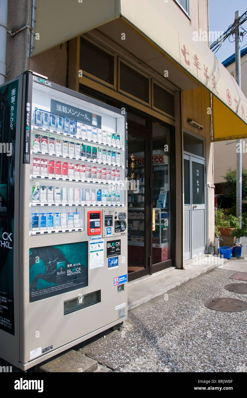 Cigarette vending machine outside a small tobacconist shop. Oita, Kyushu, Japan Stock Photo