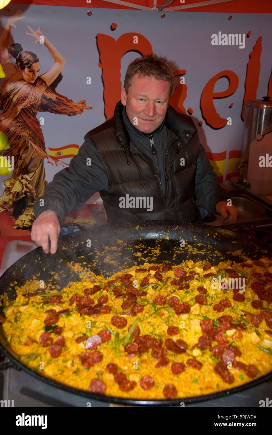 Man selling paella at the the York International Market Place, York, England. Stock Photo