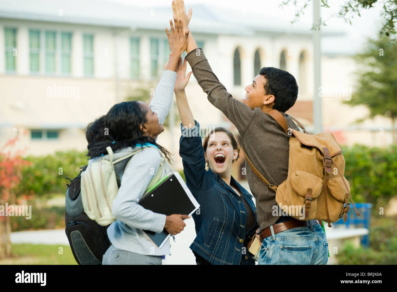 Classmates doing group highfive Stock Photo Alamy