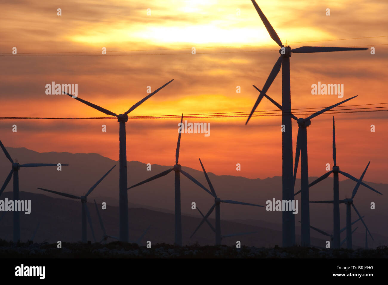 Wind turbines generating electricity at sunrise on the San Gorgonio Pass Wind Farm serving Palm Springs, California. Stock Photo