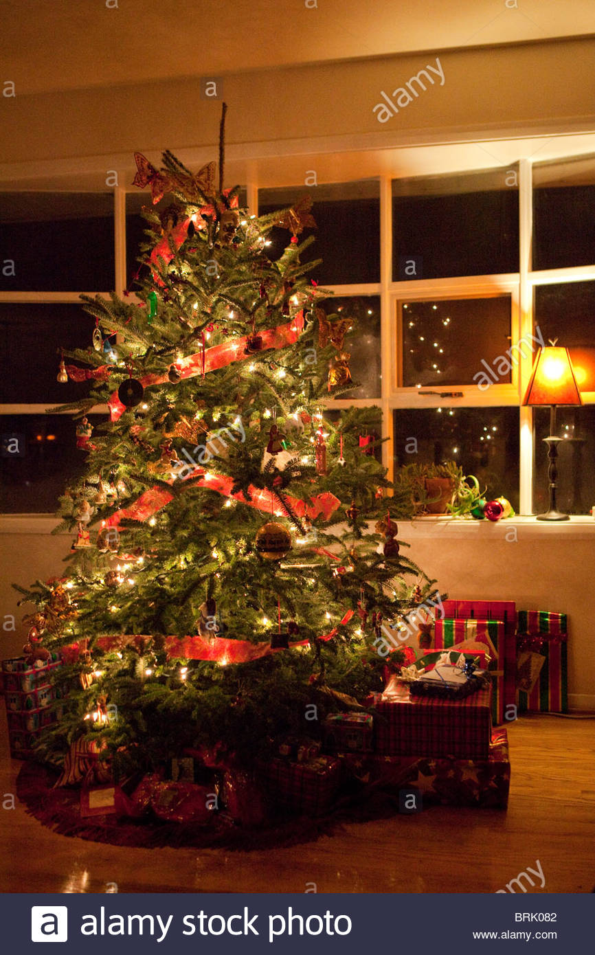 A Decorated Christmas Tree Is Lit Up At Night Inside A Warm Home Stock Photo Alamy