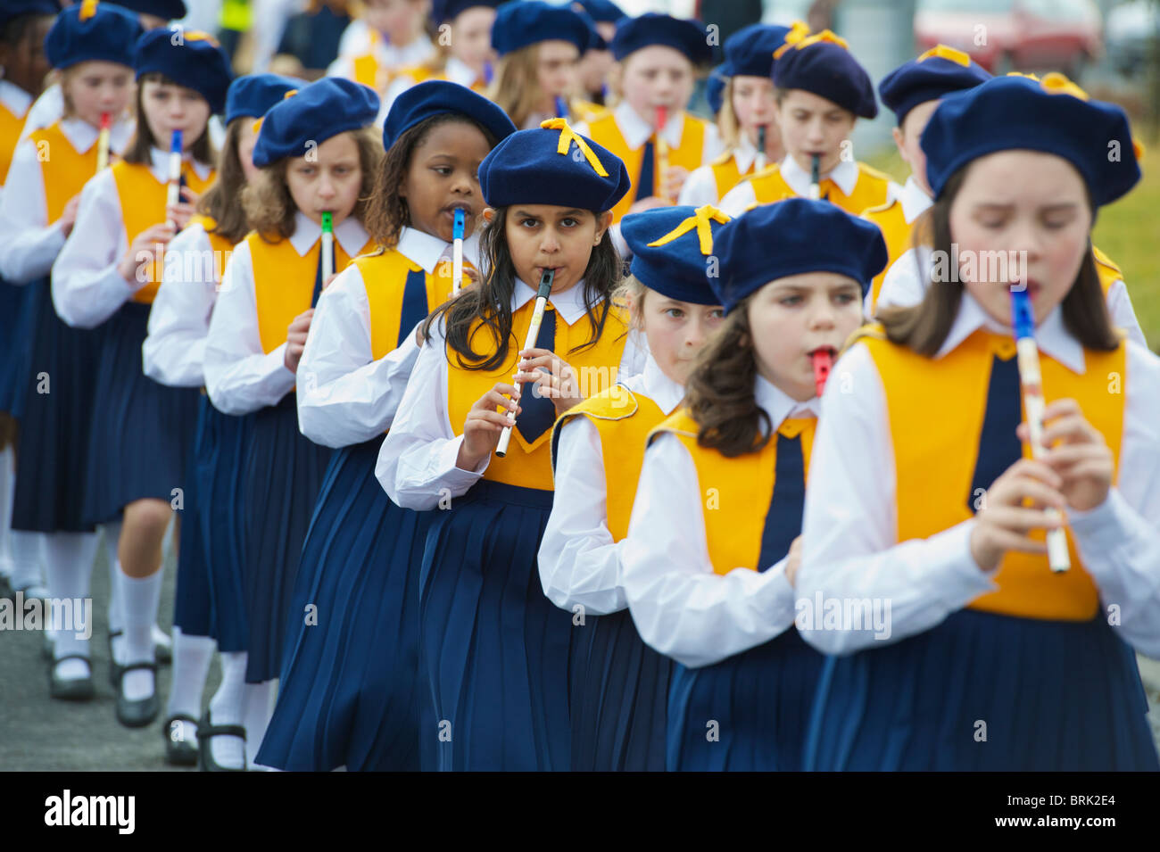 Children playing tin whistles while participating in the St. Patrick's