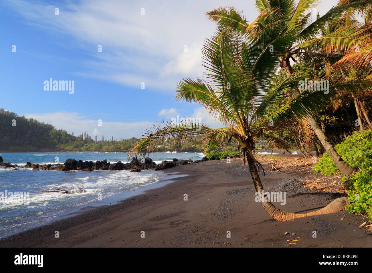 Black sand beach in Hana Bay on the northeast coast of Maui, in the town of Hana. Stock Photo
