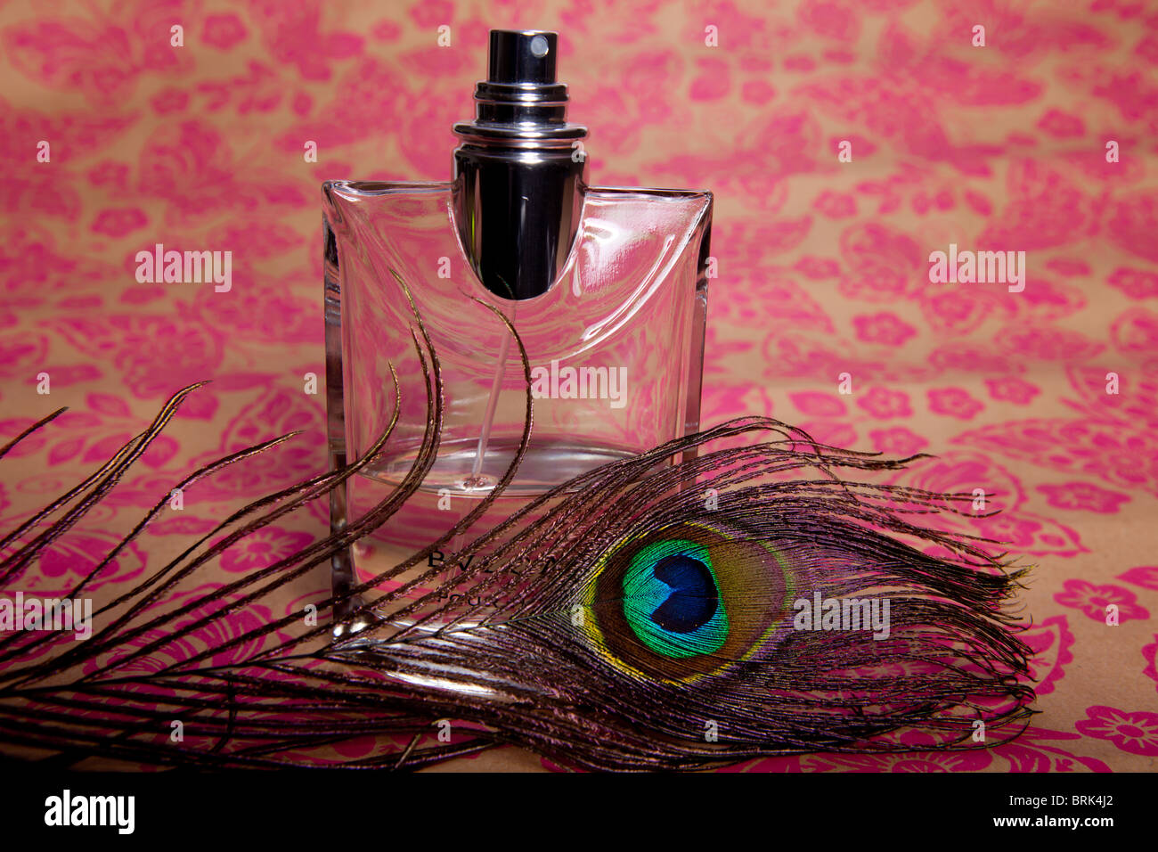 A Perfume Bottle Against A Backdrop Of Floral Wallpaper Stock Photo Alamy