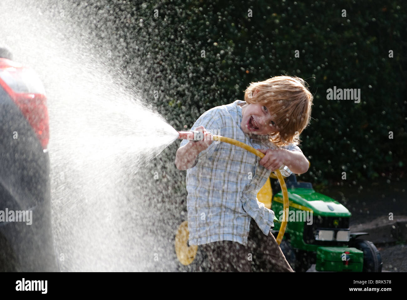 Fun with a hosepipe hi res stock photography and images alamy