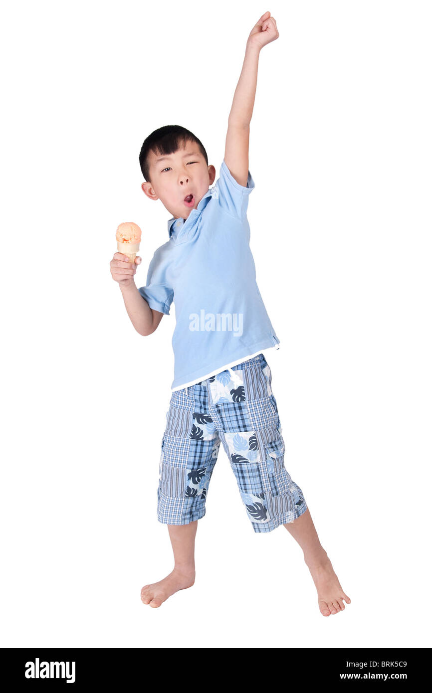 one happy asian young boy celebrating and eating ice cream isolated on white Stock Photo