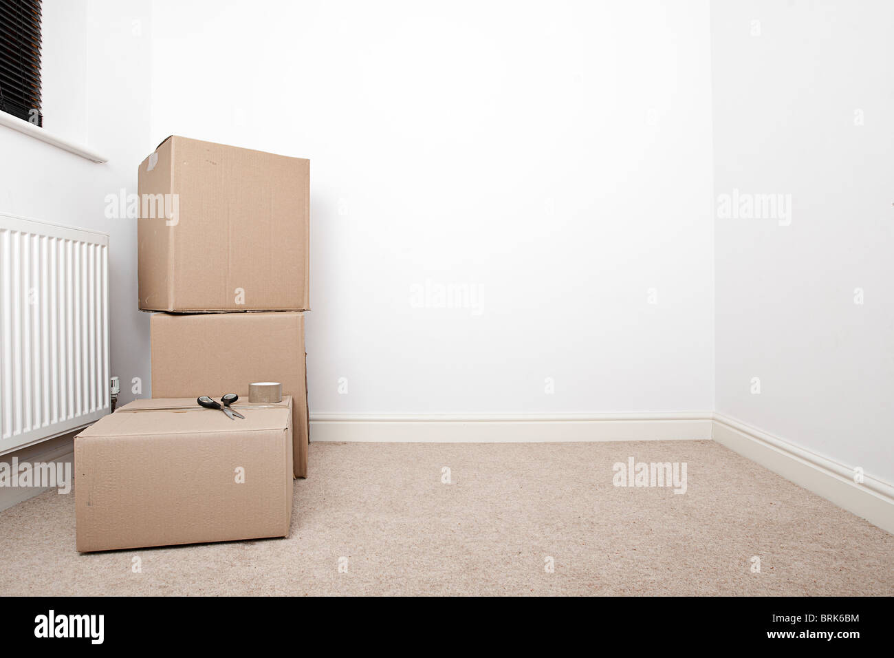 Shot of an Almost Empty Room with Removal Boxes Stock Photo