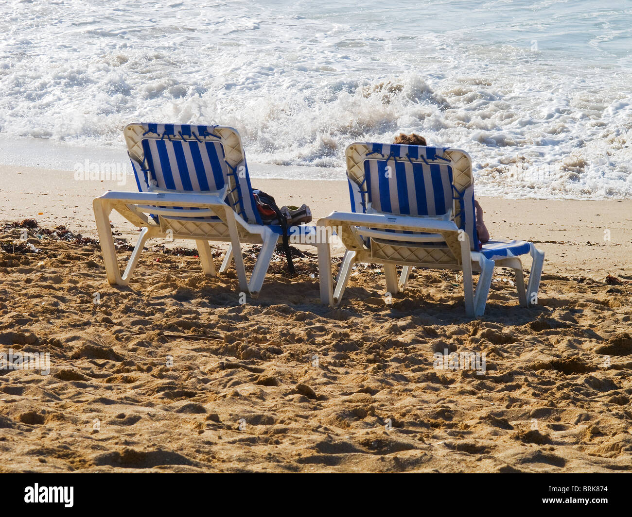 Two sunloungers on Fistral beach in Cornwall. Stock Photo