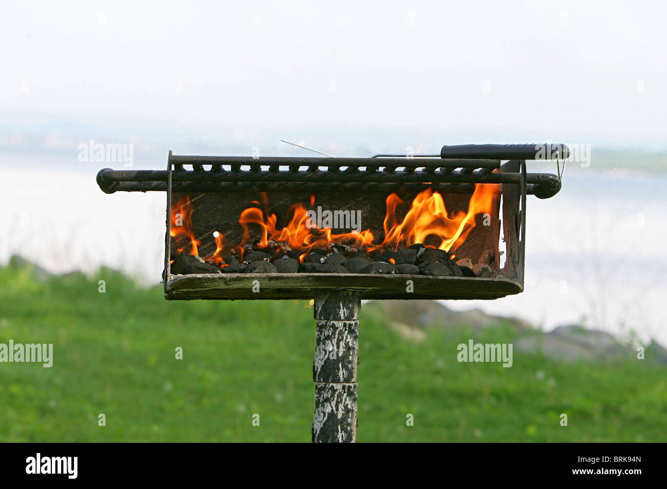 charcoal on fire heating up a barbecue pit before cooking Stock Photo