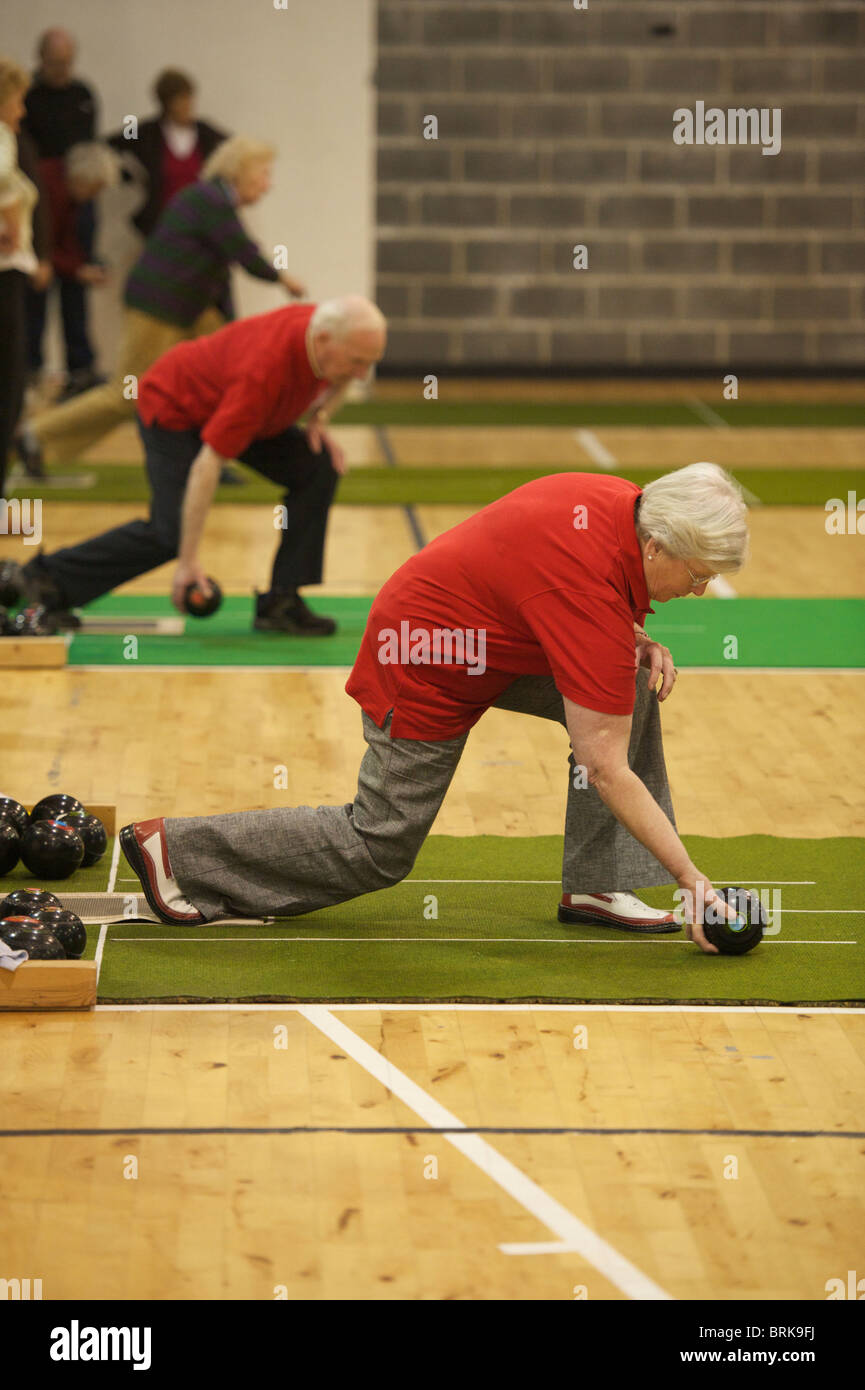 Elderly people playing indoor bowls. Stock Photo