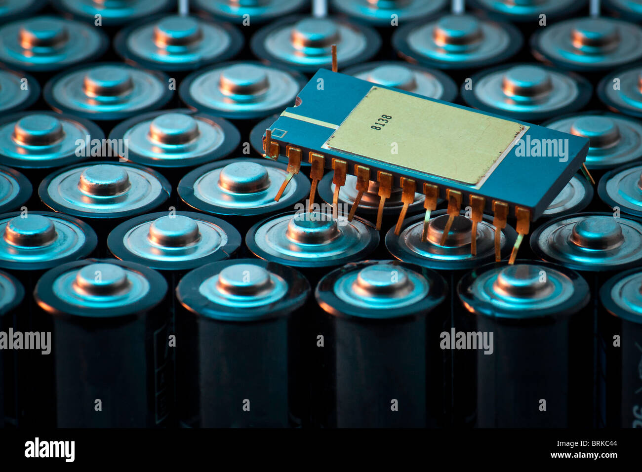 conceptual image of an insect resembling integrated circuit wandering on a cluster of batteries Stock Photo