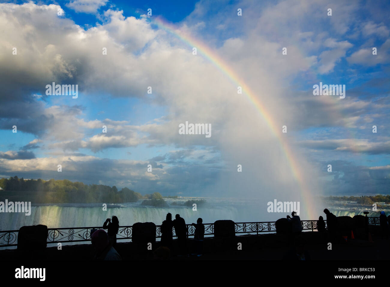 Tourists gawk at rainbow and spectacular clouds over Horseshoe Falls, Niagara Falls, Ontario, Canada Stock Photo