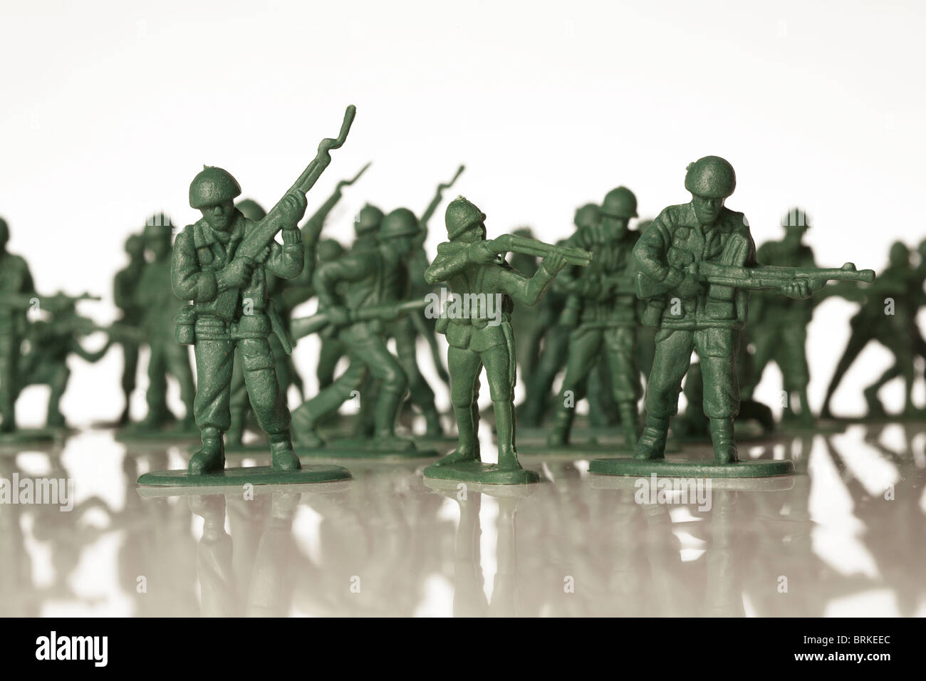 green toy soldiers out of focus in a line Stock Photo
