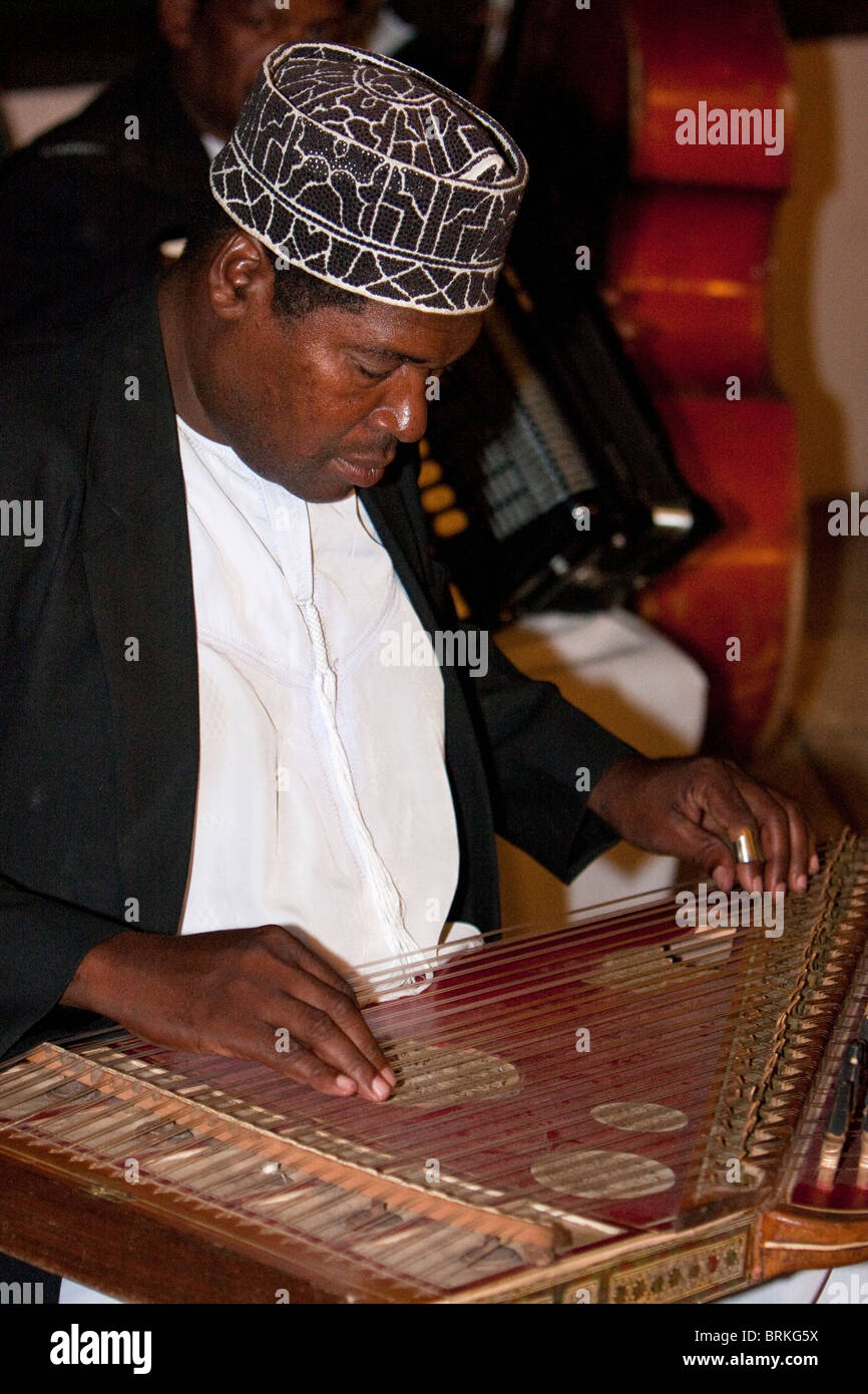 Zanzibar, Tanzania. Taarab Musicians. Culture Musical Club. Qanun Player, wearing a traditional Zanzibari hat, a kofia. Stock Photo