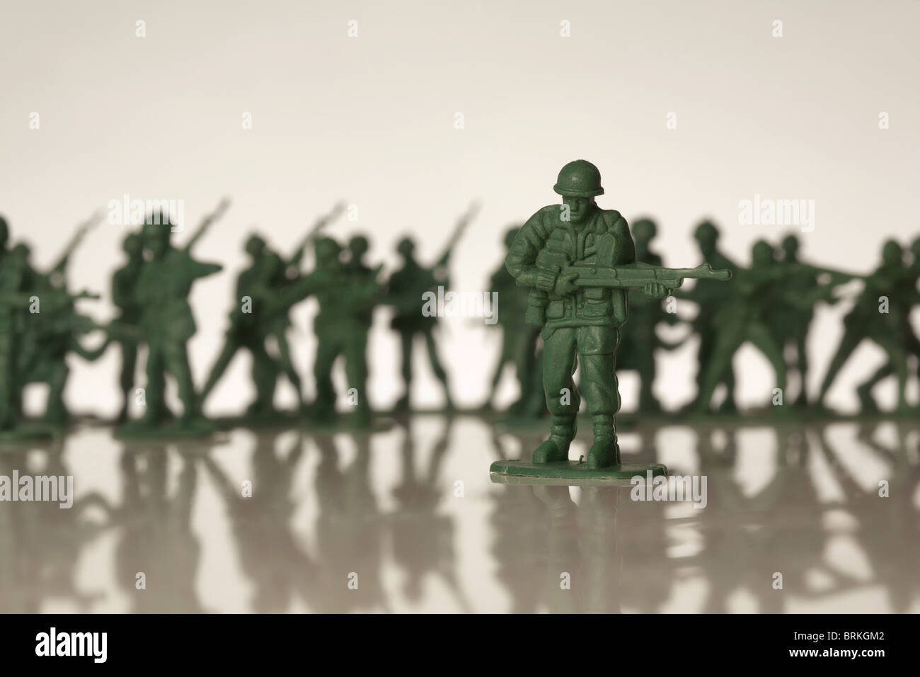 green toy soldiers out of focus in a line Stock Photo