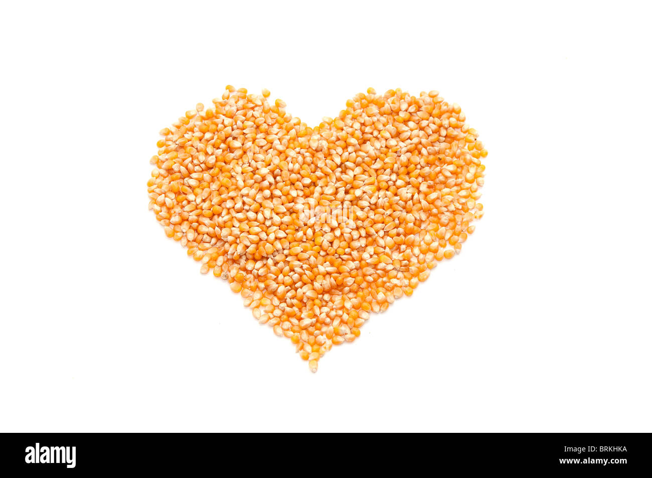 Bright corn kernels arranged in a heart shape Stock Photo