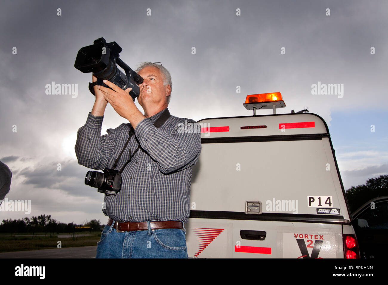 Storm chaser Tim Marshall videotapes a developing storm near North Platte, Nebraska, May 24, 2010. Stock Photo