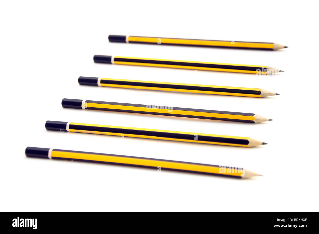Wooden graphite black and yellow pencils over a white background Stock Photo