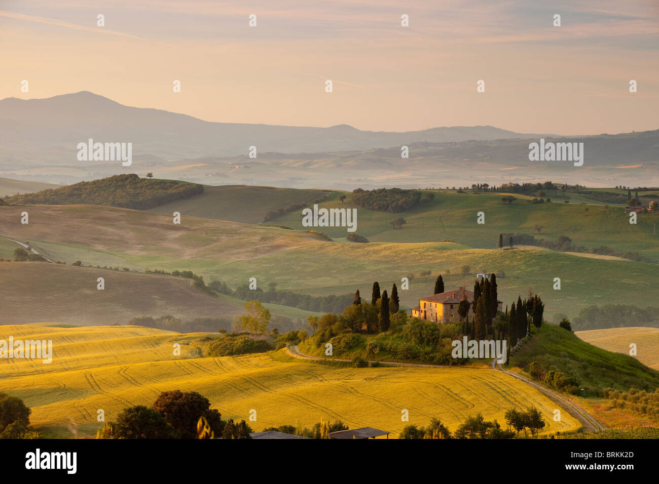 Misty dawn over Podere Belvedere and Tuscan countryside near San Quirico, Tuscany Italy Stock Photo