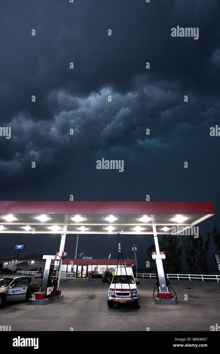A Project Vortex 2 storm chaser waits out a squall line beneath a gas station awning in Nebraska, May 24, 2010. Stock Photo