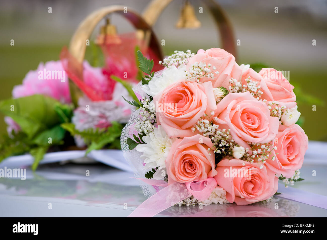 brides bouquet of roses against car wedding decoration Stock Photo