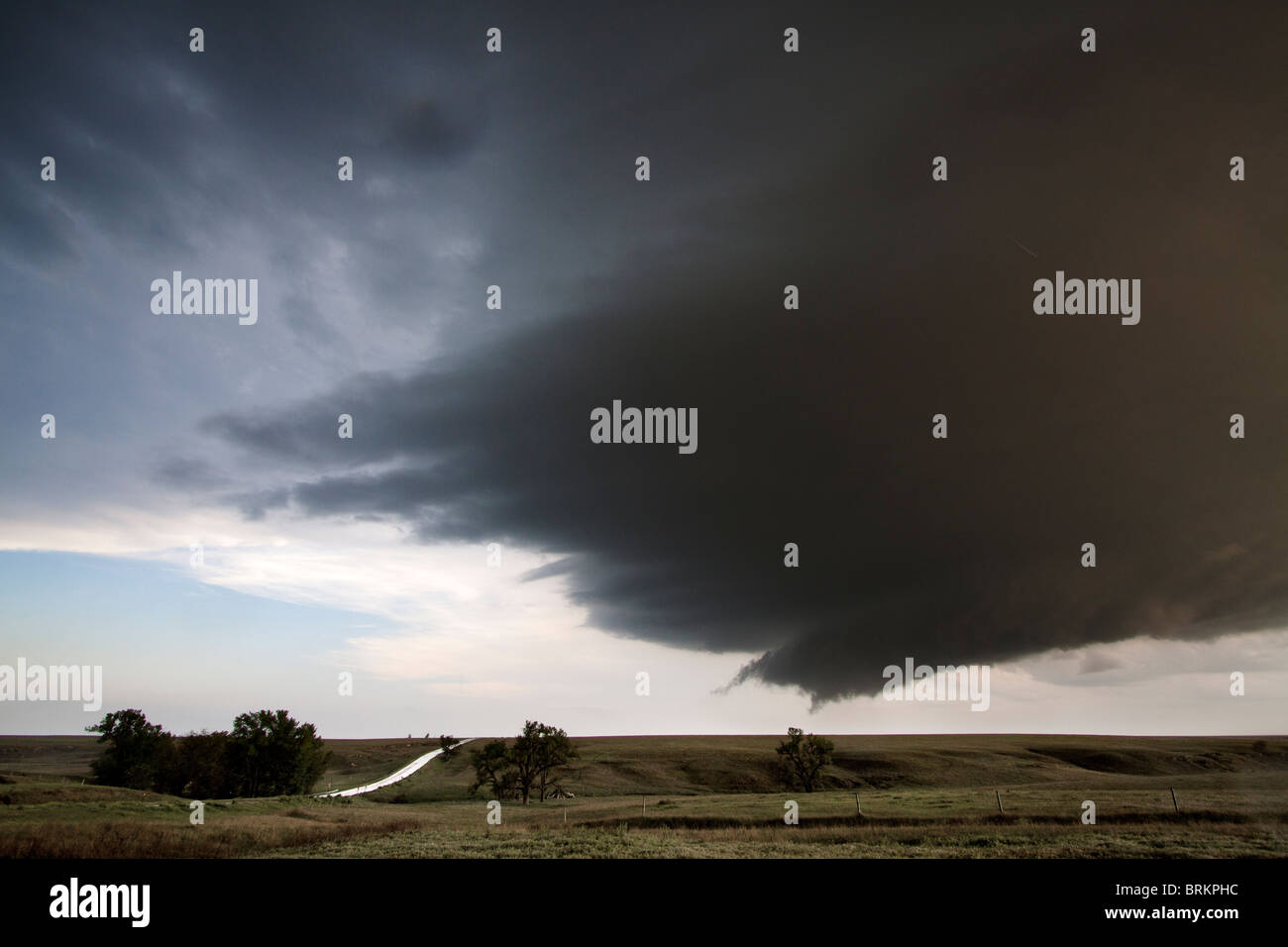 A supercellular thunderstorm with a wall cloud and a hint of a funnel cloud in Kansas, May 23, 2010. Stock Photo