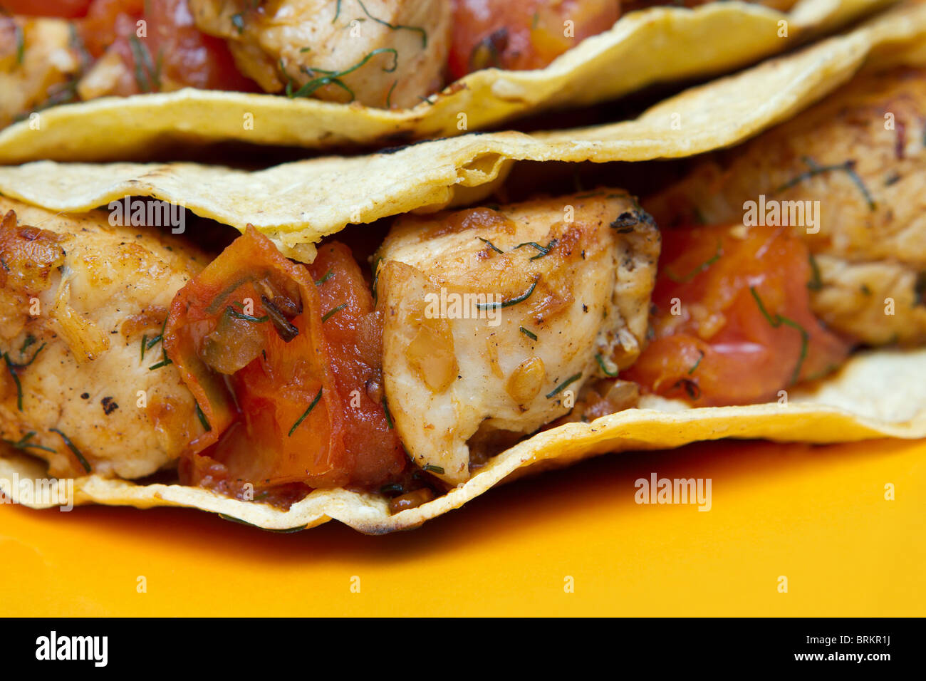 chicken tacos closeup on a yellow plate Stock Photo