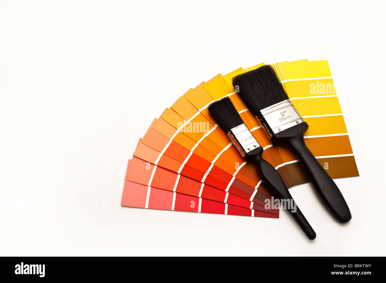 Fan of colour swatches with two paintbrushes Stock Photo