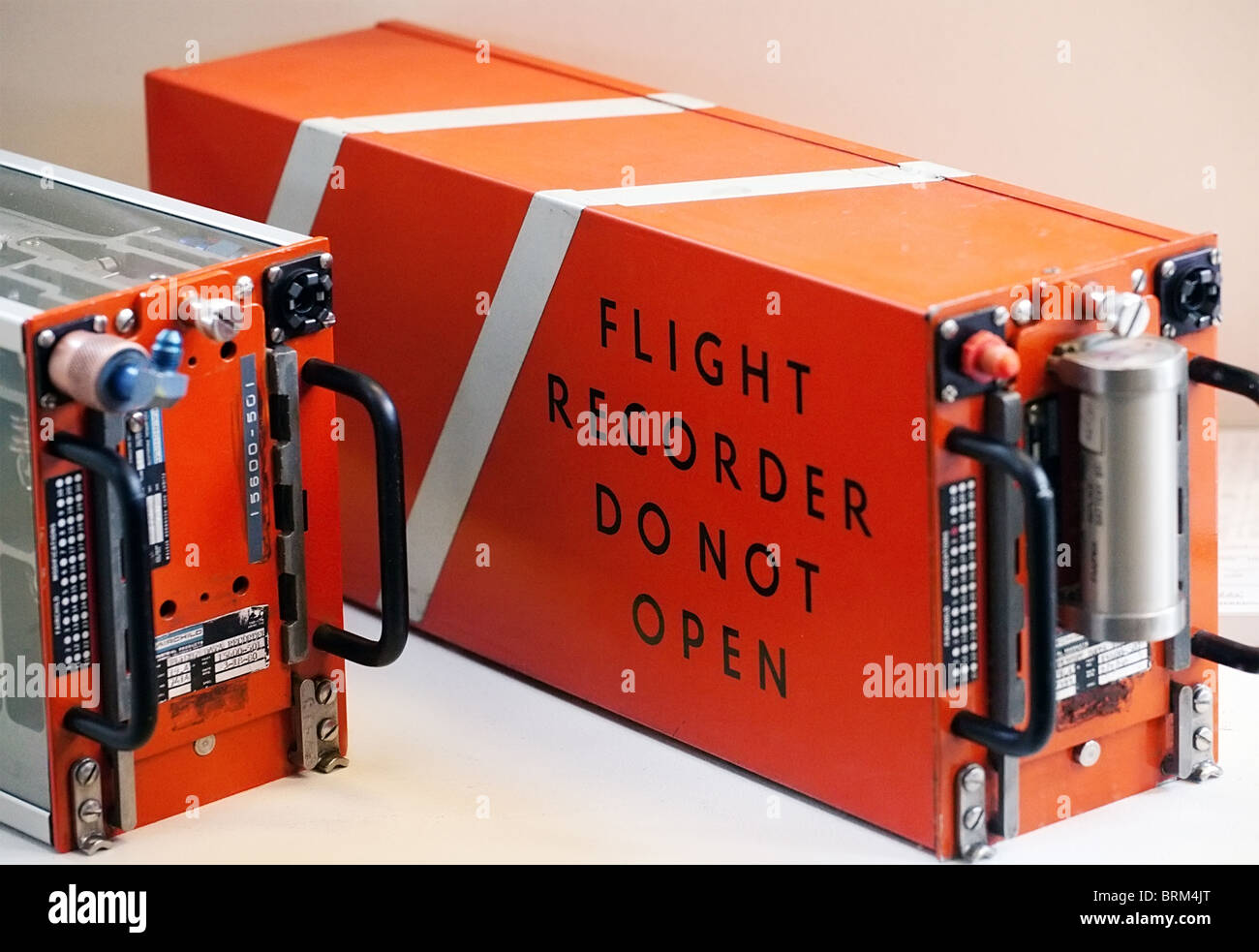 flight recorder, blackbox: orange box from a plane, closeup on white background Stock Photo
