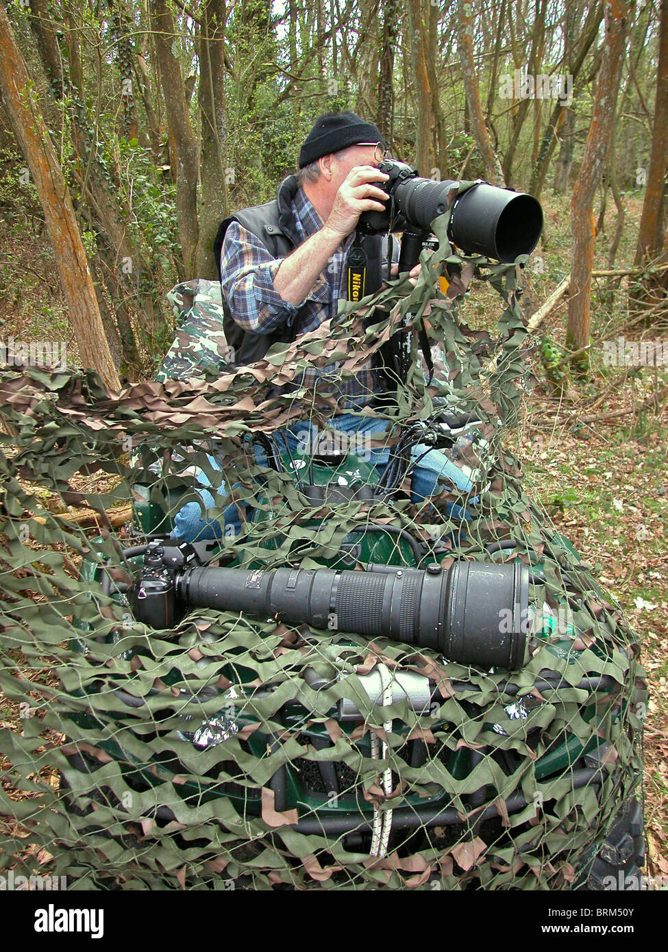 Photographing wildlife requires long lenses camo netting and patience.  Photographer David Cole on the way to a location Stock Photo - Alamy