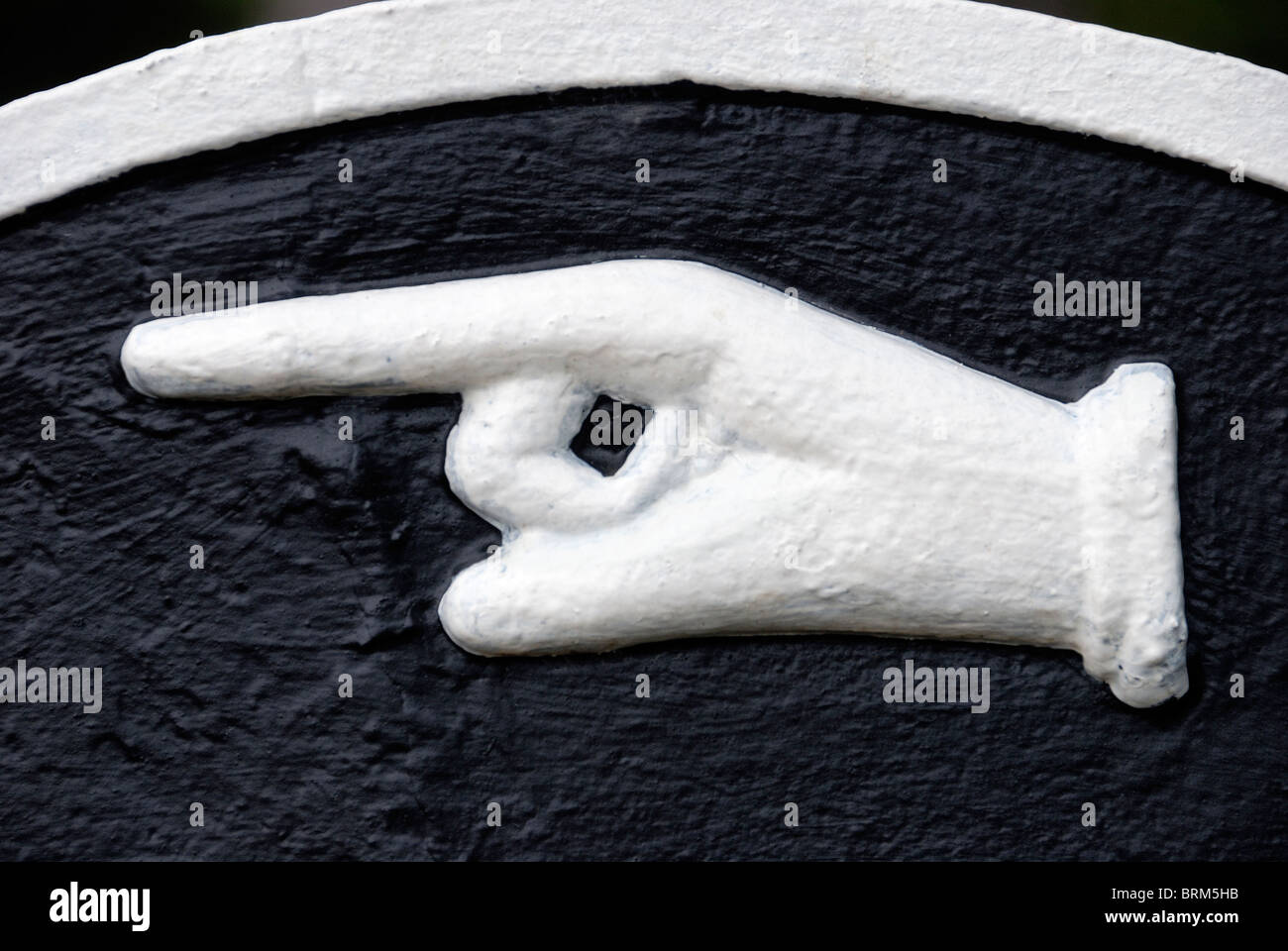 Close-up of pointing finger on a sign Stock Photo