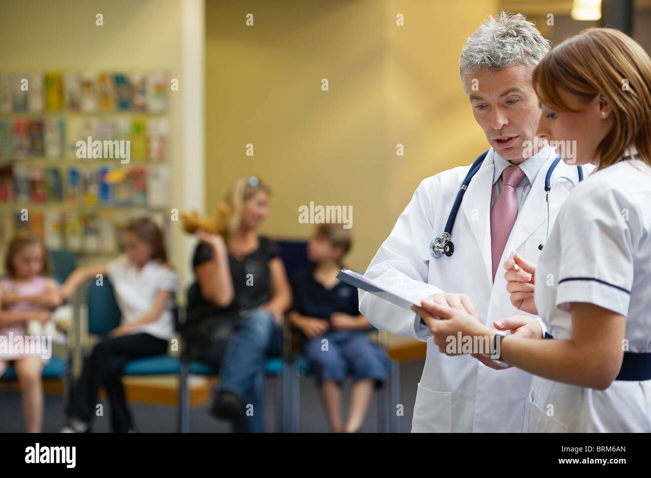 Doctor and nurse in waiting area Stock Photo