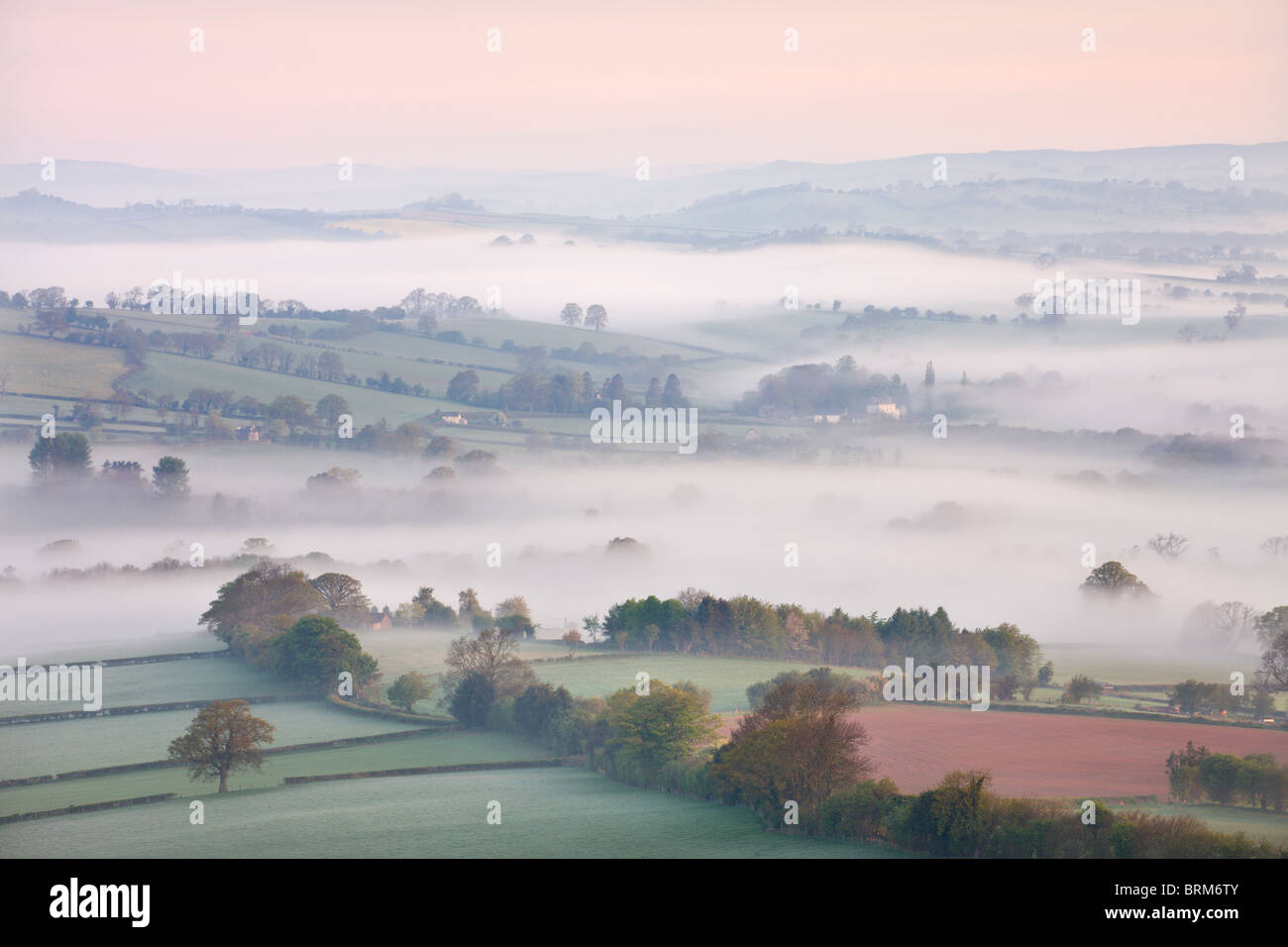 Mist covered countryside at dawn near Pennorth, Brecon Beacons National Park, Powys, Wales. Spring (May) 2010. Stock Photo