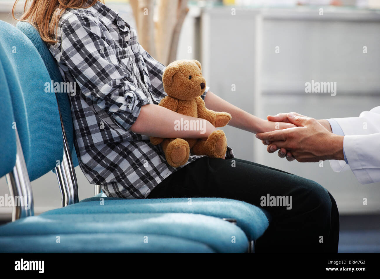 Doctor holding young girls hand Stock Photo