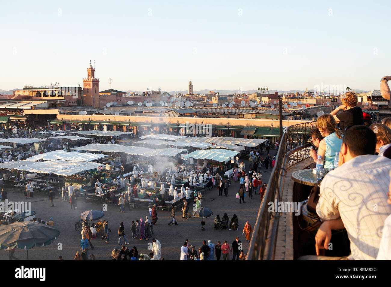 MARRAKESH: TOURISTS WITH ELEVATED FROM ROOFTOP CAFE VIEW TO DJEMAA EL FNA Stock Photo