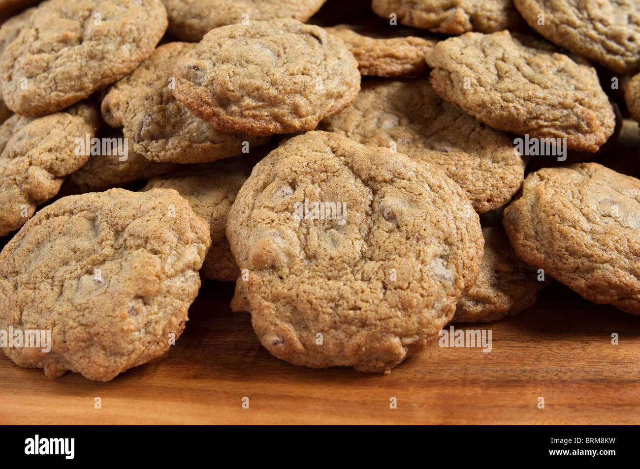 small stack of gluten free chocolate chip cookies on a wooden cutting board Stock Photo