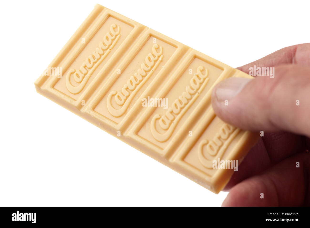 Bar of Nestle Caramac white chocolate being handed out Stock Photo