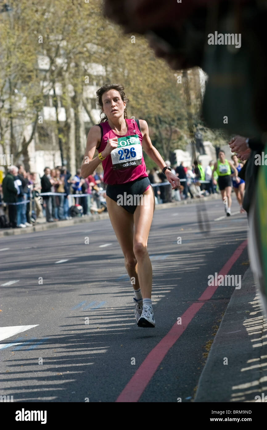 lady runner taking part in the London Marathon running through the