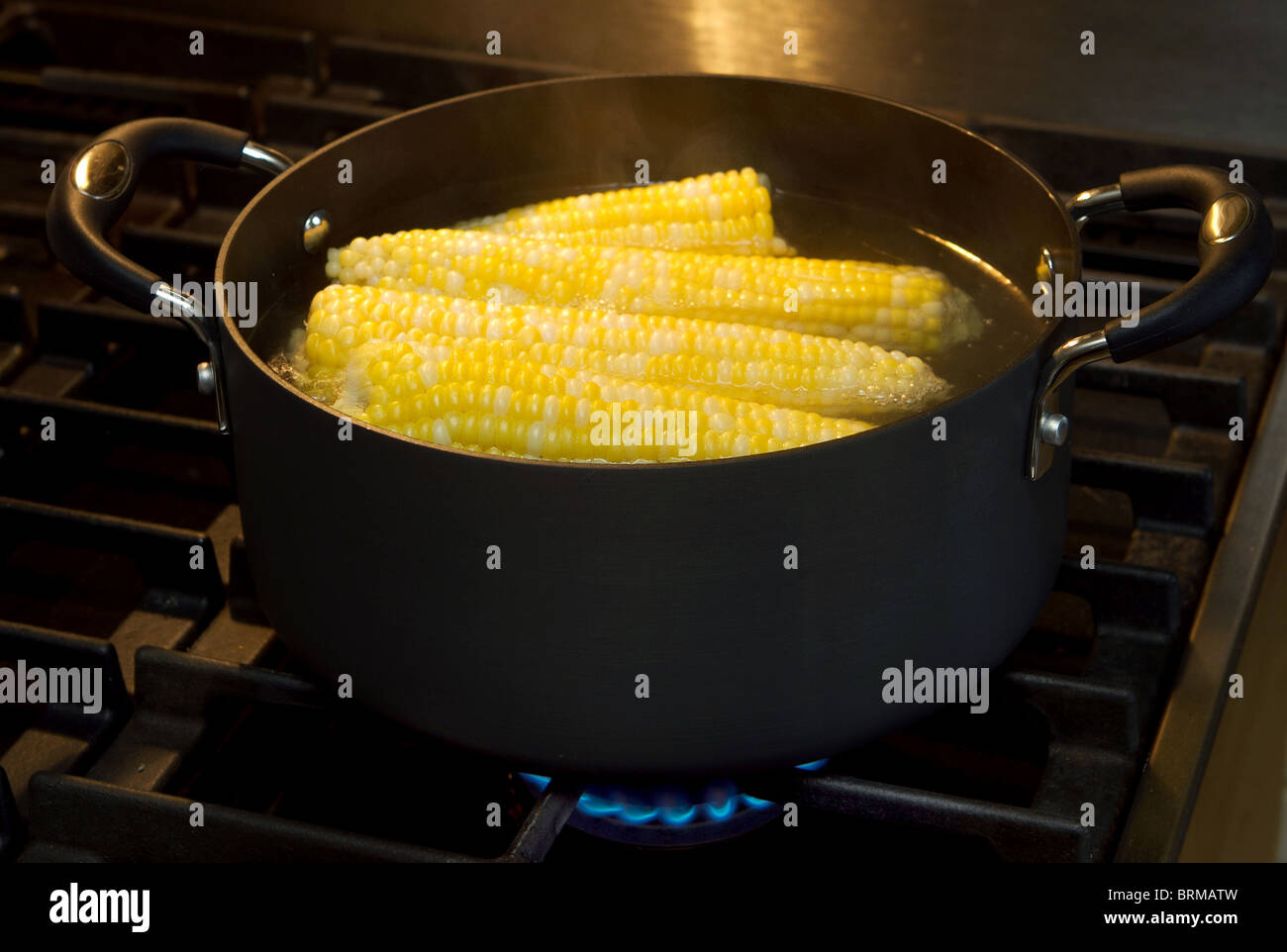 corn on the cob boiling on a gas stove Stock Photo Alamy