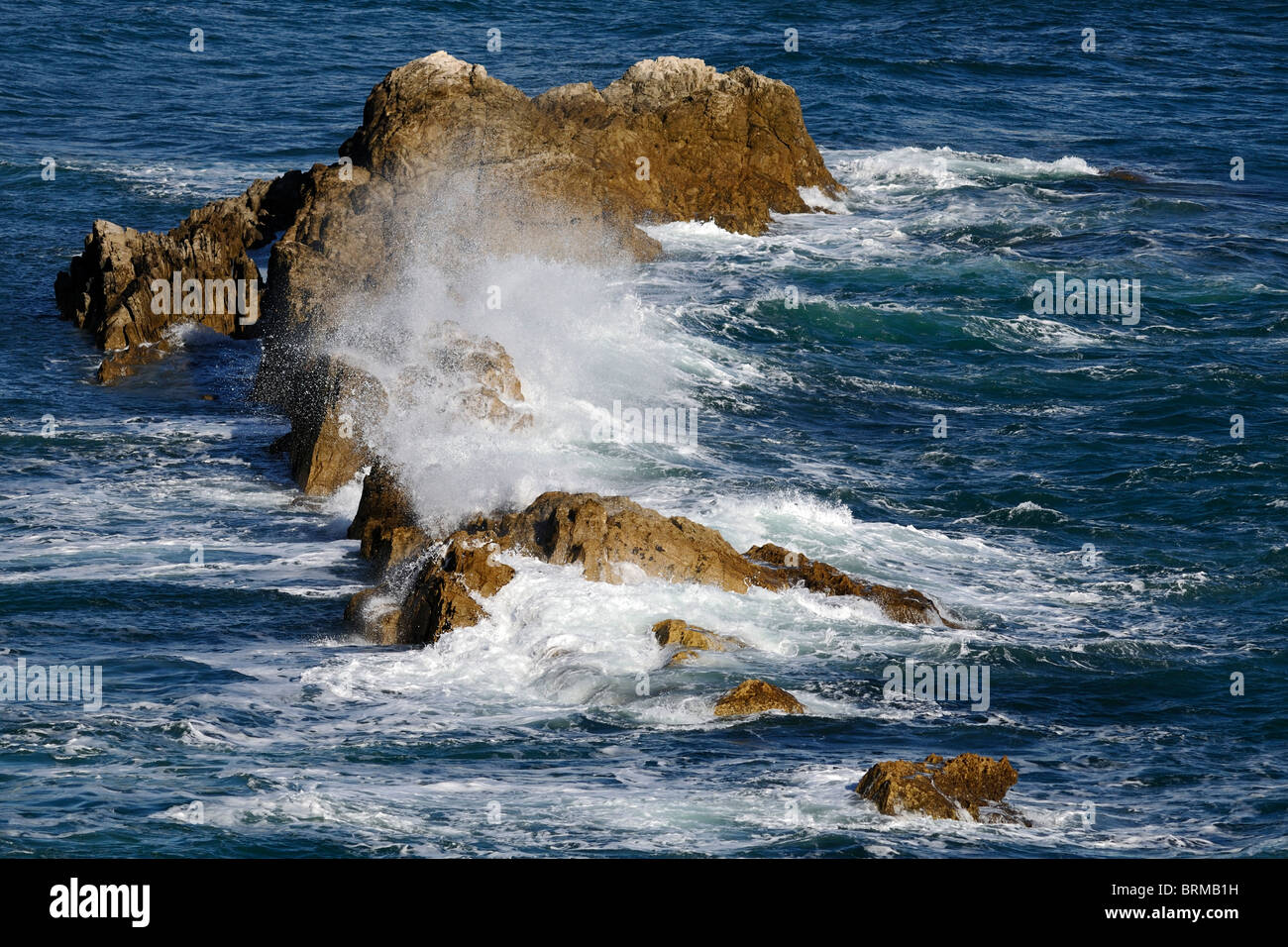Sea foam and spray about the Man O' War Rocks, St Oswald's Bay, Dorset, England Stock Photo
