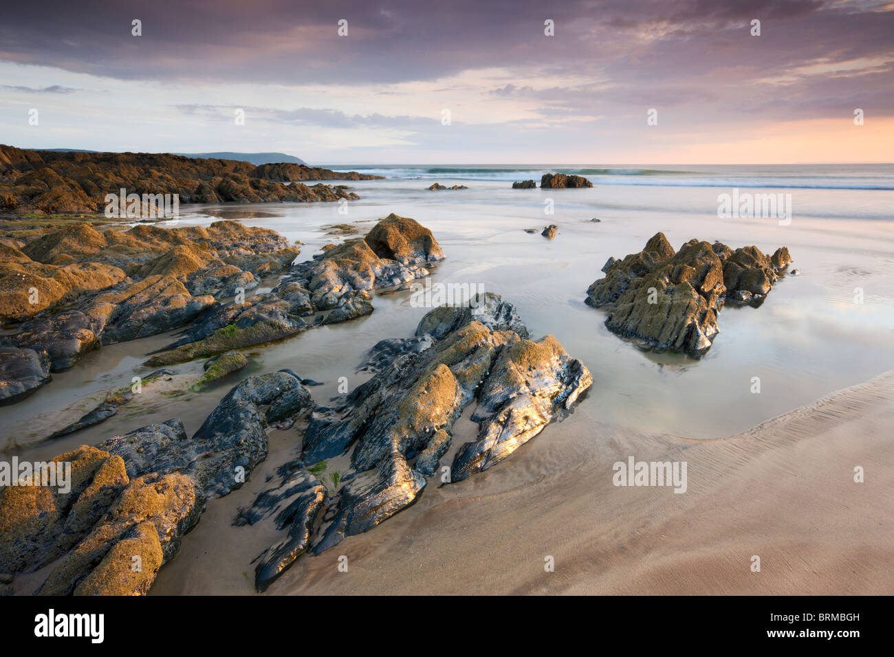 Low tide at sunset on Combesgate Beach at Woolacombe, Devon, England. Summer (June) 2010. Stock Photo