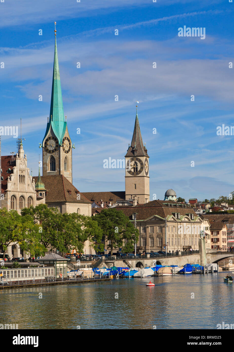 looking across the Limmat river at the Fraumunster abbey and St Peters church, in Zurich, Switzerland. Stock Photo