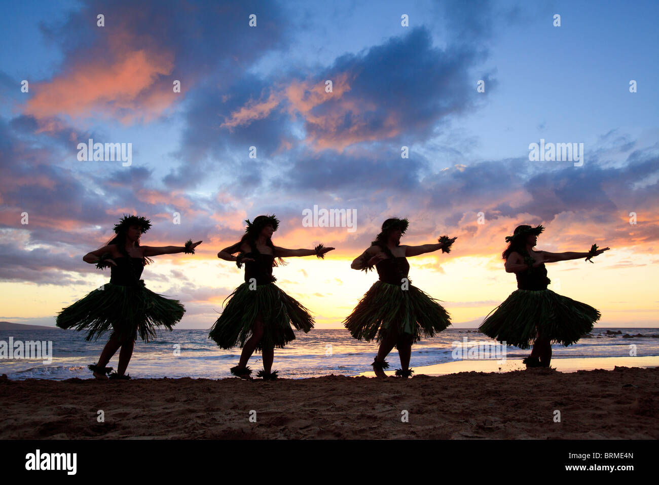 Silhouette of hula dancers at sunset at Palauea Beach, Maui, Hawaii. Stock Photo